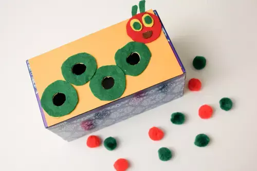 Classroom craft of a very hungry caterpillar made from paper plates with each day labelled and filled with the food the caterpillar ate in the story. (Very Hungry Caterpillar activities)