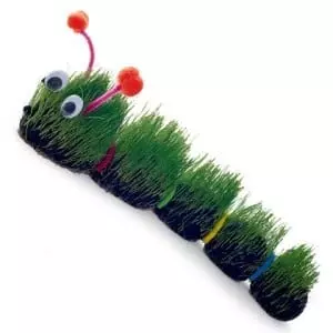 A caterpillar craft made from segments of dirt and grass with googly eyes and pipe cleaner antennae (Very Hungry Caterpillar activities)