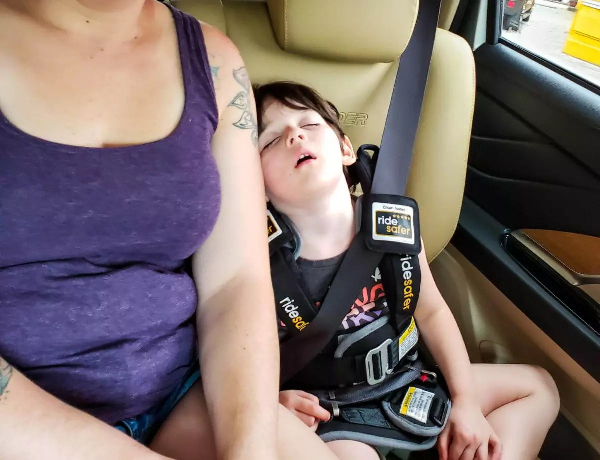 child asleep in RideSafer Travel Vest