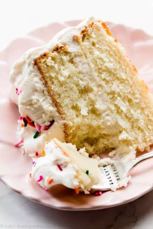 cake with whipped frosting and rainbow sprinkles