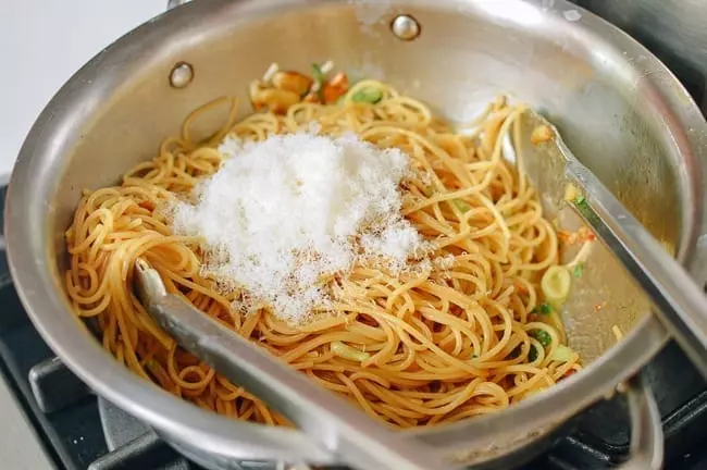 Adding Cooked Pasta and Parmesan Cheese to Sauce