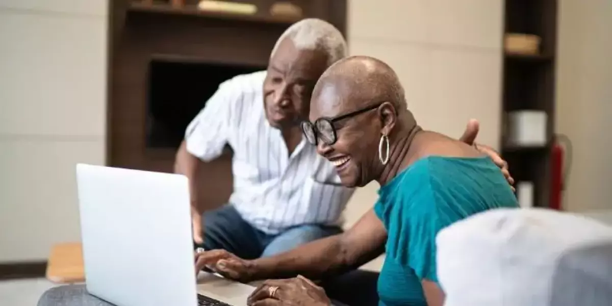 Senior couple smiling looking at Staysure travel insurance reviews