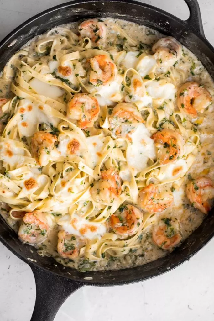 Creamy shrimp fettuccine alfredo pasta bake is garlicky, buttery, cheesy, loaded with shrimp + parsley and topped with mozzarella. Easy comfort food goals.