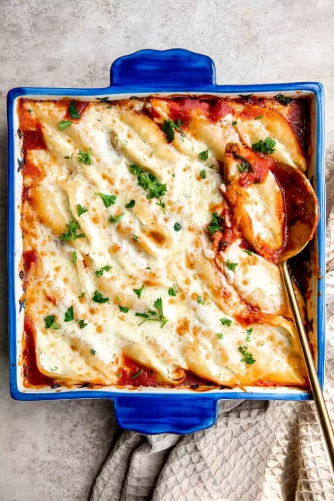 Ricotta stuffed shells are an easy, hearty, and classic Italian comfort food that can feed the whole family. Easy to make ahead and freeze for another day.