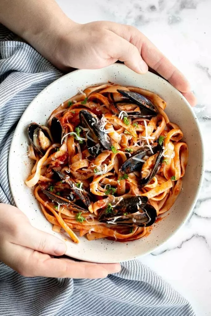 Mussels pasta in tomato sauce is a simple, light and fresh seafood pasta dinner that can be made at home in 30 minutes. The easiest weeknight dinner.