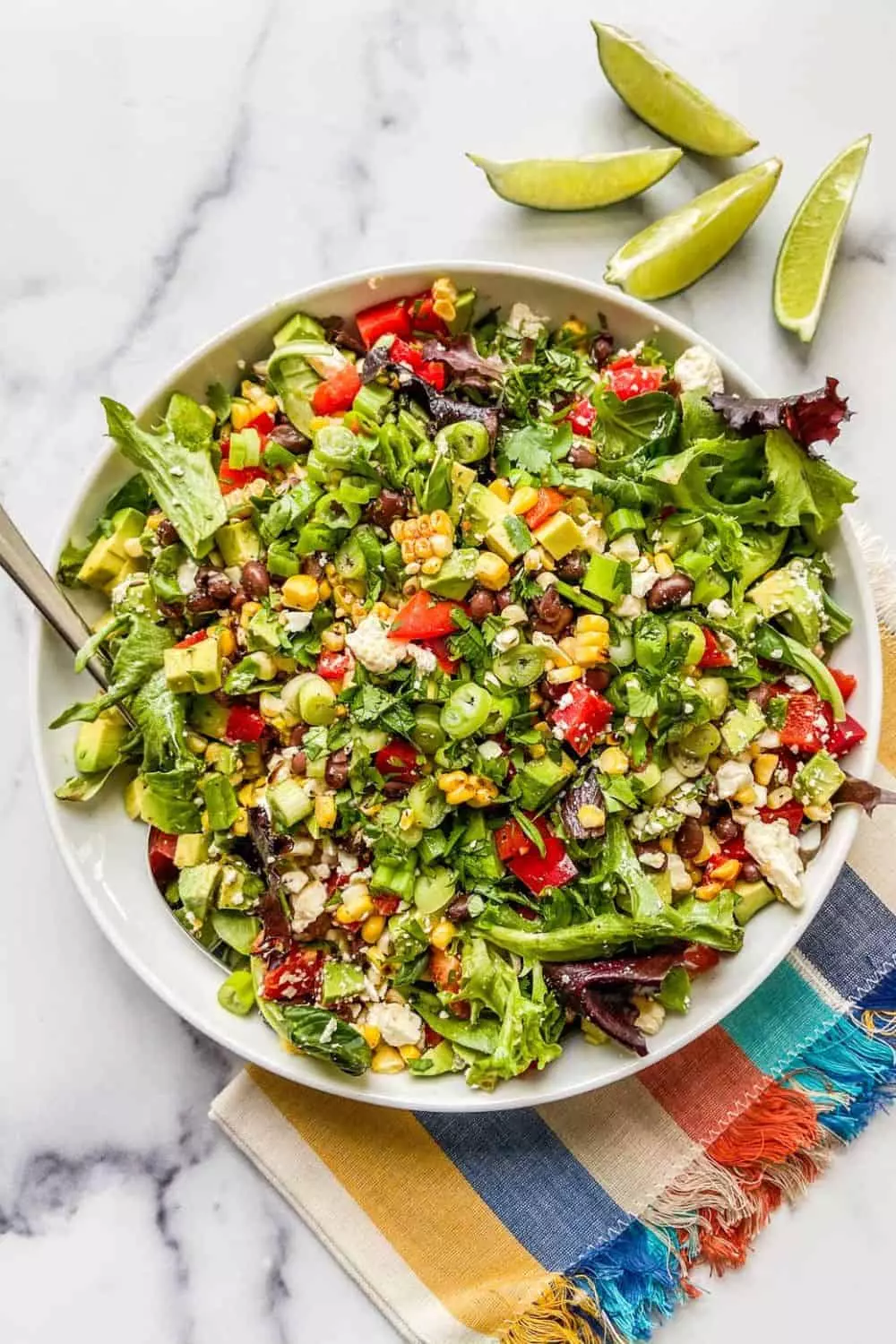 Grilled corn salad with black beans and bell peppers in a serving bowl.