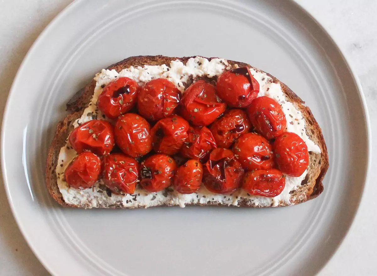 ricotta cheese roasted tomatoes basil balsamic toast on grey plate and marble counter