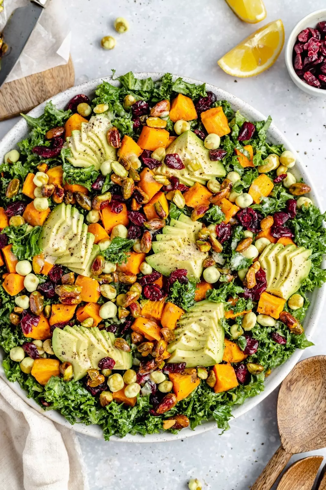 Picture of sweet potato kale salad in a bowl topped with avocado