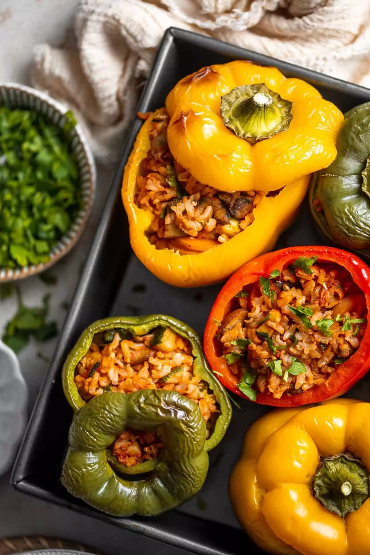 Vegan Stuffed Peppers are stuffed with pan-fried mushrooms, tender rice, and veggies, making them flavorful and filling. Easy to make in under an hour!