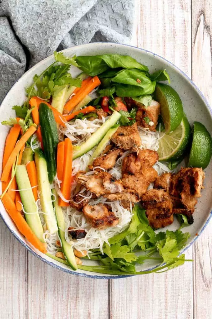 Vietnamese noodle bowl with lemongrass chicken, fresh vegetables, and herbs, tossed in a homemade Vietnamese sauce is healthy, delicious, light, and filling.