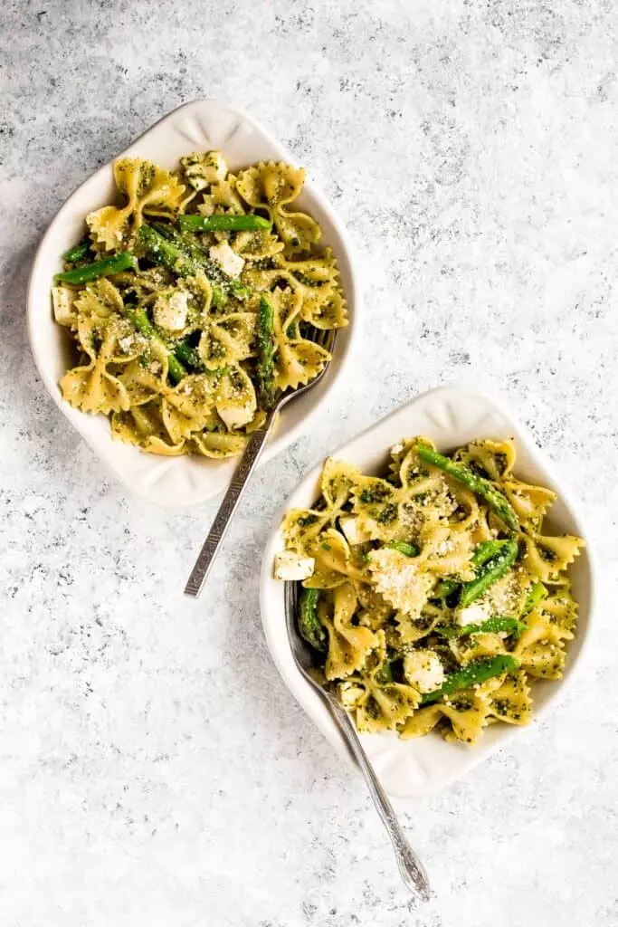 Spring pesto pasta with asparagus and chives is light and made with simple ingredients in under 20 minutes. Serve it hot for dinner or cold as a pasta salad.