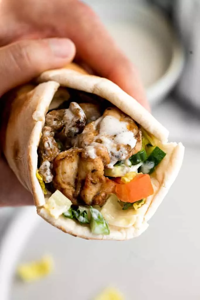 Homemade chicken shawarma with juicy tender chicken marinated in Middle Eastern spices and wrapped in pita bread is easy to make at home.