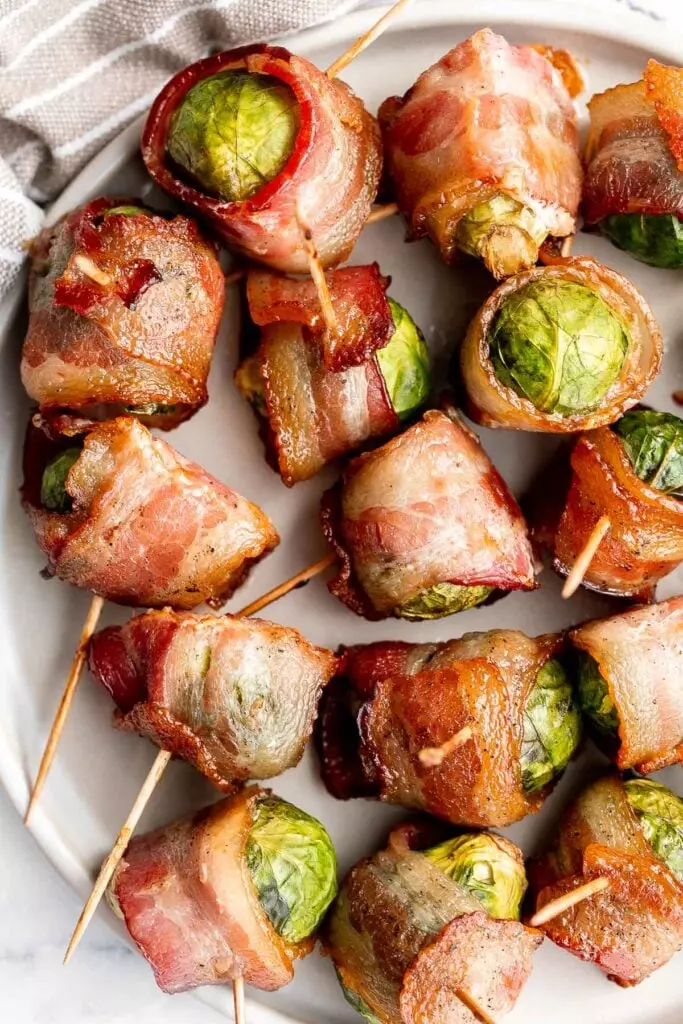 Bacon wrapped Brussels sprouts are the sweet, savory, and salty appetizer that you need at your next holiday gathering. Simple and easy to make.