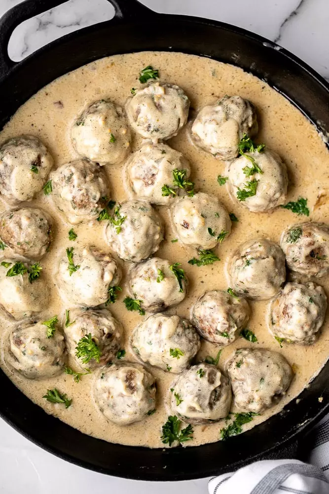 Delicious, comforting homemade Swedish meatballs are seared and smothered in a creamy gravy sauce. They taste so much better than IKEA meatballs.
