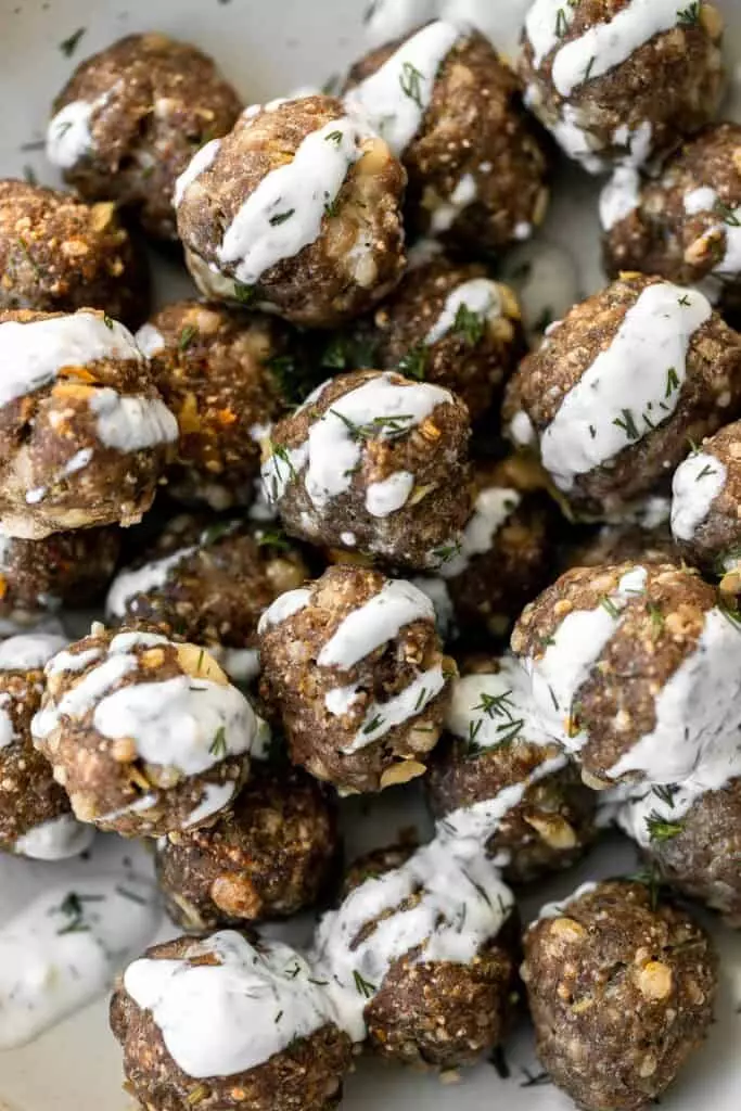 Greek meatballs are juicy, tender, flavorful, and delicious. They're quick and easy to make in 30 minutes, and freezer-friendly. Serve with tzatziki sauce.