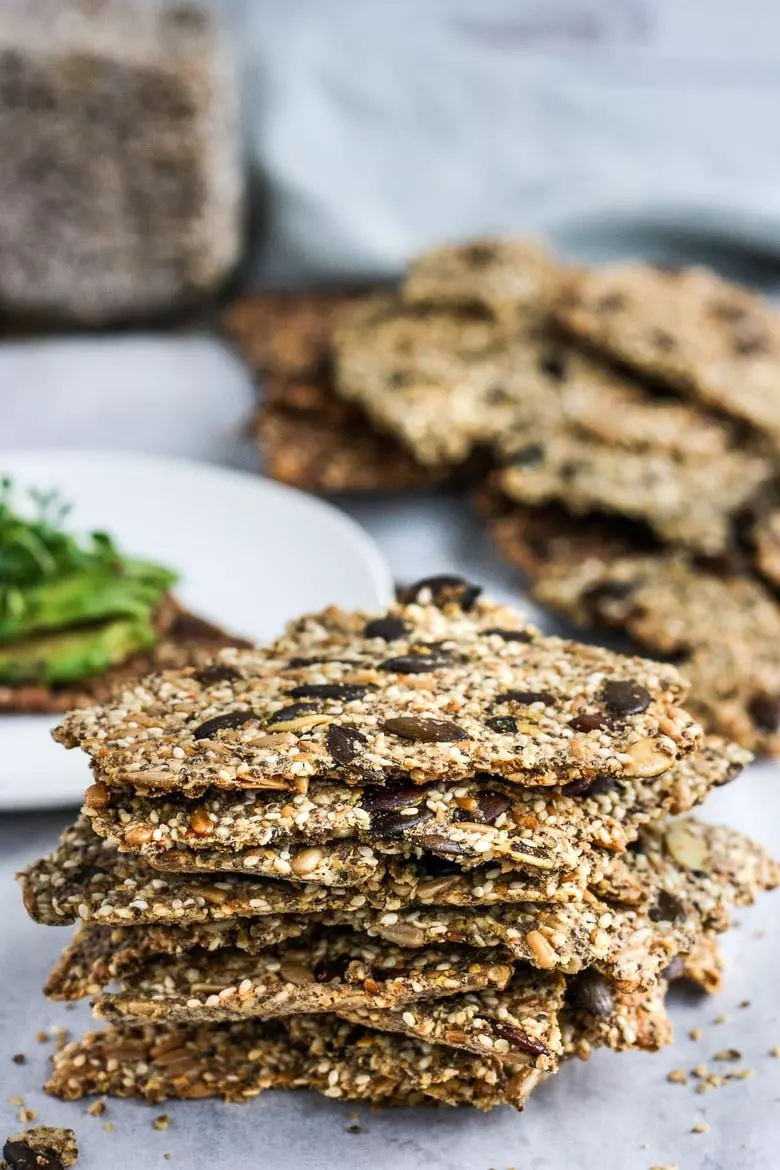 Light and crisp, these Rustic Seed Crackers are keto, gluten-free, and vegan. This recipe is incredibly easy, flexible, adaptable, and full of toasty rich flavor. They are the perfect snack by themselves and pair with most toppings. #ketocrackers #keto #crackers #seededcrakers #seedcrackers