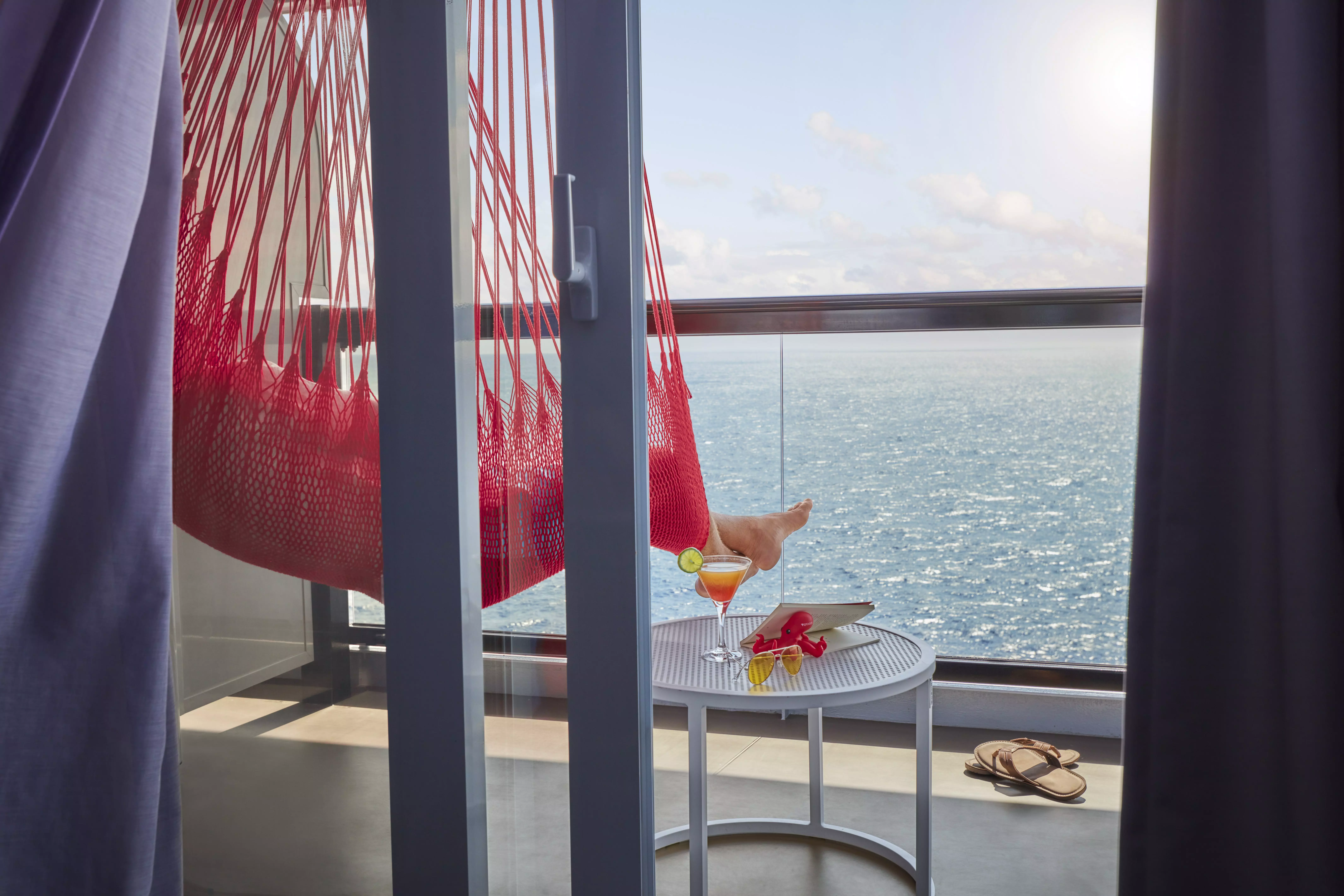 Red hammocks on the terrace are a signature Virgin Voyages amenity.